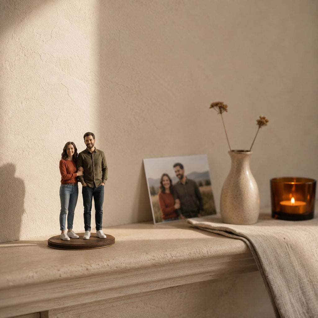 Couple figurine on a shared base beside their photo