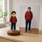 Full-colour voxel figurine on a walnut base beside its source photo on a clean desk